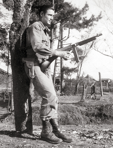 Johnnie R. Long poses with a Tommy Gun in Kyoto, Japan.